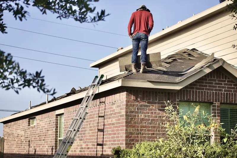 Professional roofer working on a residential roof in Chalk Point